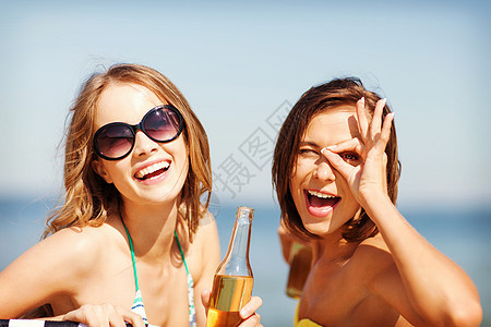 暑假假期比基尼女孩海滩椅子上喝饮料图片