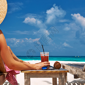 美丽的海滩上躺椅的女人图片
