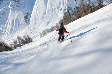 滑雪者从雪山上滑下图片