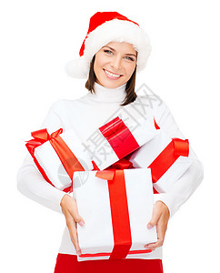 诞节,冬天,幸福的微笑的女人戴着诞老人的帽子,很多礼品盒图片