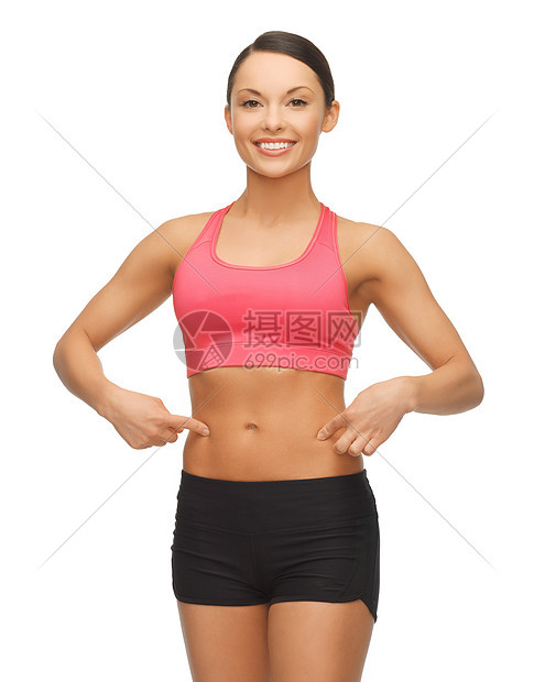 美丽的运动女人手指她的腹部图片