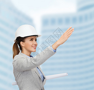建筑,开发,建筑友好的轻微笑建筑师白色头盔与蓝图图片