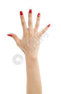 用红色指甲涂白色上的手的照片图片