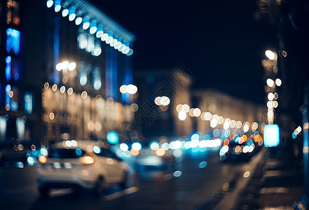 夜晚模糊的城市博克美丽的抽象背景与分散的建筑,汽车,城市灯,人五颜六色的背景与城市夜景背景古董图片