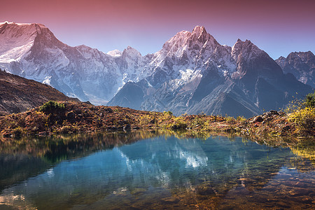 美丽的风景与高山积雪覆盖的山峰,天空反射湖泊中日出时水中反射的山谷尼泊尔喜马拉雅山脉的惊人景象自然日出时图片