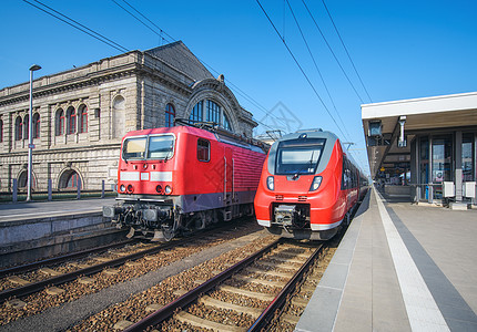 日落时火车站上的高速列车旧列车纽伦堡,德国铁路站台上的现代城际列车工业铁路上的通勤火车客运火车站上的高图片
