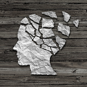 阿尔茨海默病患者医学心理健康护理的张被撕破的皱巴巴的白纸,形状像个人的脸的侧轮廓,个古老的粗糙的木头背景上,图片