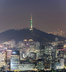 韩国首尔市中心城市景观的空中日落夜景与首尔塔图片