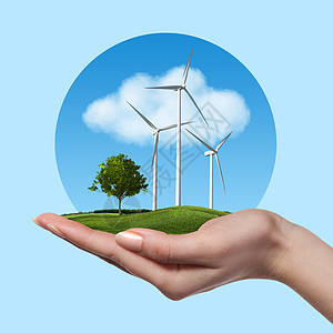 草地上树的风力涡轮机握着女人的手,抗蓝天云彩绿色能源风力涡轮机,女手中树图片