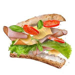 三明治与下降的成分空气中分离的白片新鲜西红柿,火腿,奶酪生菜图片