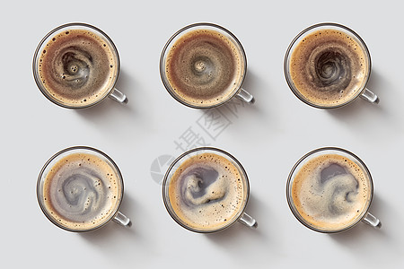 顶部的许多杯子与咖啡泡沫灰色的背景早上的咖啡很香套杯子与热咖啡与泡沫灰色背景的风景背景图片