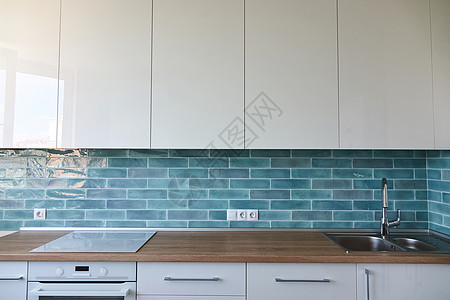 厨房里的棕色台,水槽,蓝色瓷砖,内部背景个漂亮的新厨房内部图片