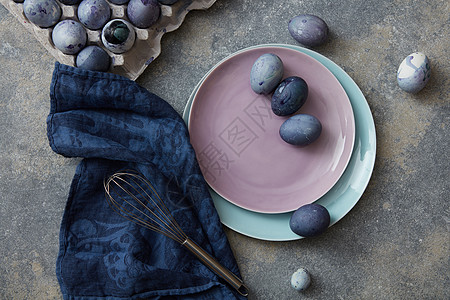 复活节彩蛋用蓝布搅拌石头背景五颜六色的复活节彩蛋图片