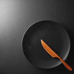 黑色盘子,刀纹理黑色背景上黑色盘子,背景上刀图片