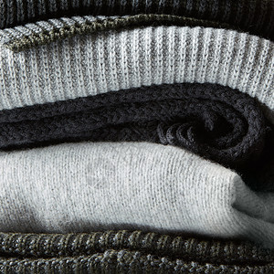 衣服上的素材背景上的针冬衣,毛衣,针物,背景上的堆针冬季衣服背景