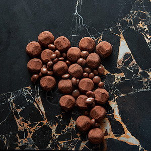 各种黑巧克力松露与可可粉饼干黑暗的大理石背景各种黑巧克力松露图片