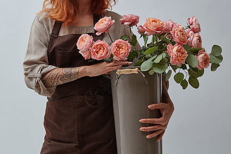 个纹身的女人着个大花瓶,粉红色的媒体玫瑰母亲节花店的着花瓶玫瑰的女孩图片