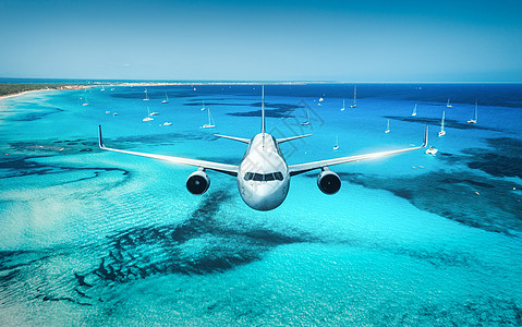 飞机夏天日出时飞越岛屿海洋风景与白色客机,海滨,船只,天空蔚蓝的水白色客机旅行度假空中视野图片