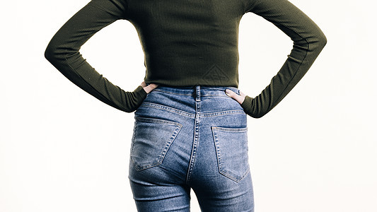 目全非的女人向后站着,穿着紧身的蓝色牛仔裤,露出臀部的曲线穿着蓝色牛仔裤的女人站后图片