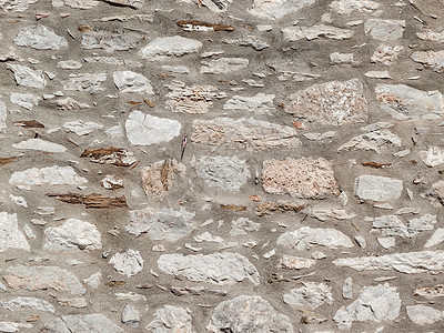 由石砖制成的墙纹理,背景古代风格希腊的建筑细节由石砖制成的墙图片