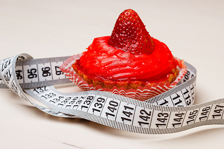 食欲贪食的育肥问题桌上测量带的蛋糕纸杯蛋糕图片