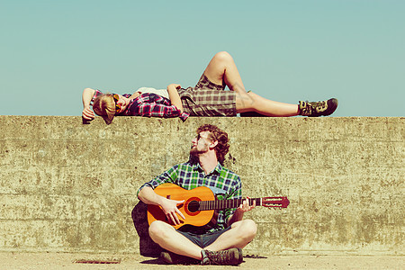 轻人海边约会的时候,户外给女朋友弹吉他图片