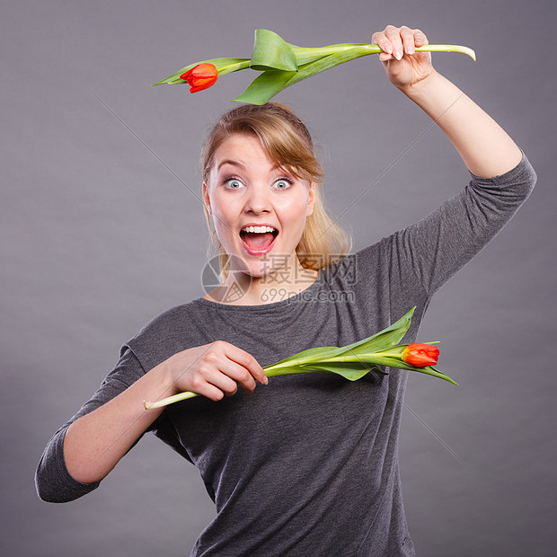 快乐的微笑,趣的积极的女,用郁金香疯狂的人物好玩的女孩玩花郁金香