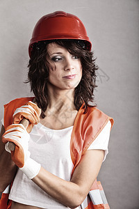 别平等女权主义感女孩戴着安全帽,橙色背心,着工具建筑工人工作的吸引力的女人图片