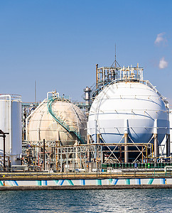 位于日本东京附近的川崎市的化工厂,拥气体储存管道结构,烟气来自烟囱背景图片