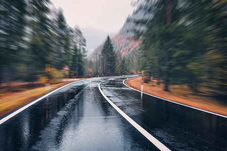 秋林雨中运动模糊的效果，沥青山路阴雨天,背景模糊道路中公路快速驾驶图片