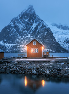 红海沿岸的红罗布夜间白雪覆盖的山挪威洛福腾群岛穆迪冬季景观与传统挪威罗布尔,倒影水,雪岩老渔夫家图片
