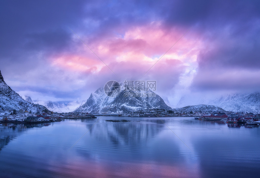 雪山的鸟瞰,海边的村庄,冬天日落时的紫色天空莱茵河,洛芬岛,挪威的顶级景观穆迪景观与高岩石,房屋,罗布,反射水中图片