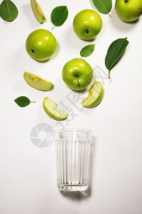 汁从新鲜苹果片流到玻璃杯中图片