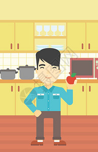 一名在厨房里吃苹果的年轻人图片