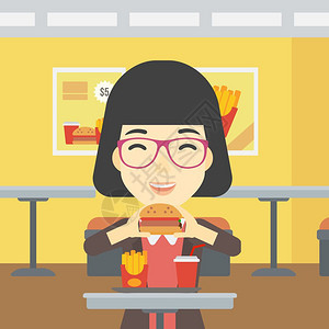 一位亚洲年轻女吃汉堡包图片