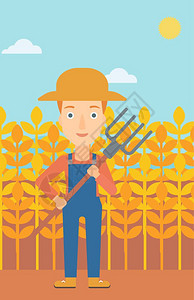 一名手持草叉站在小麦田里的女性农民图片