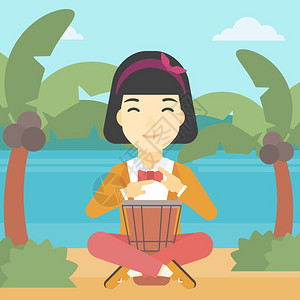 一名在海滩上玩民族鼓的女性图片