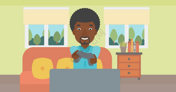 一名坐在沙发上玩游戏的开心的非裔男子图片