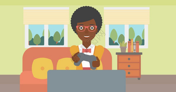 一名坐在沙发上玩游戏的开心的非裔女子图片