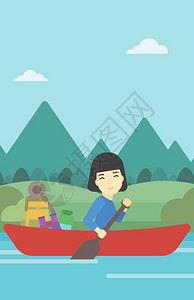一名亚裔女子骑在河边的一条皮艇上图片