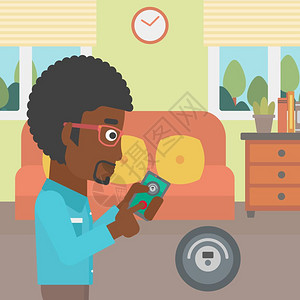 用智能手机控制真空吸尘器的非裔男子图片