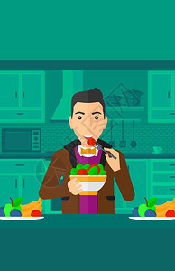 一个在厨房中吃水果沙拉的男子图片