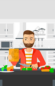一个长着胡子在厨房中切菜的男子图片