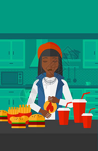 一位站在厨房快餐前感到胃痛的非裔女子图片