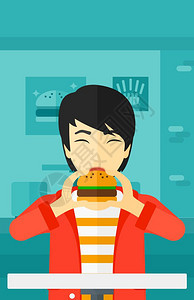 吃汉堡的年轻男子图片