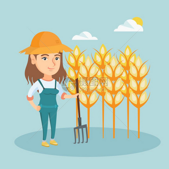 穿着工作服的年轻女农夫手拿草叉站在小麦田前图片
