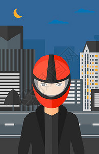 戴头盔的人及夜间城市背景图片
