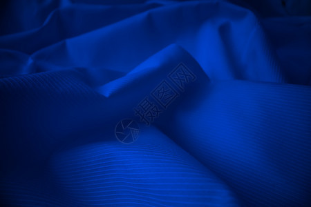 光亮的流布纹理在宏观镜头中卷状的清洁丝绸织物纺抽象背景图片