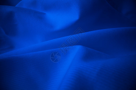 光亮的流布纹理在宏观镜头中卷状的清洁丝绸织物纺抽象背景图片
