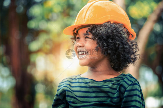 小朋友带着黄色安全帽体验工程师图片